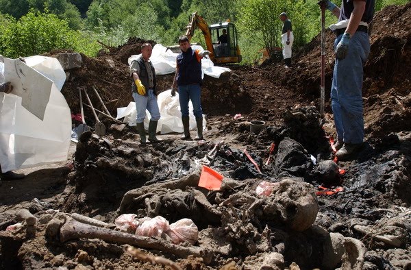 Forensic team of the ICMP inspects remains of the Bosniak victims - women, children, and the elderly - in the Zaklopaca mass grave. 
